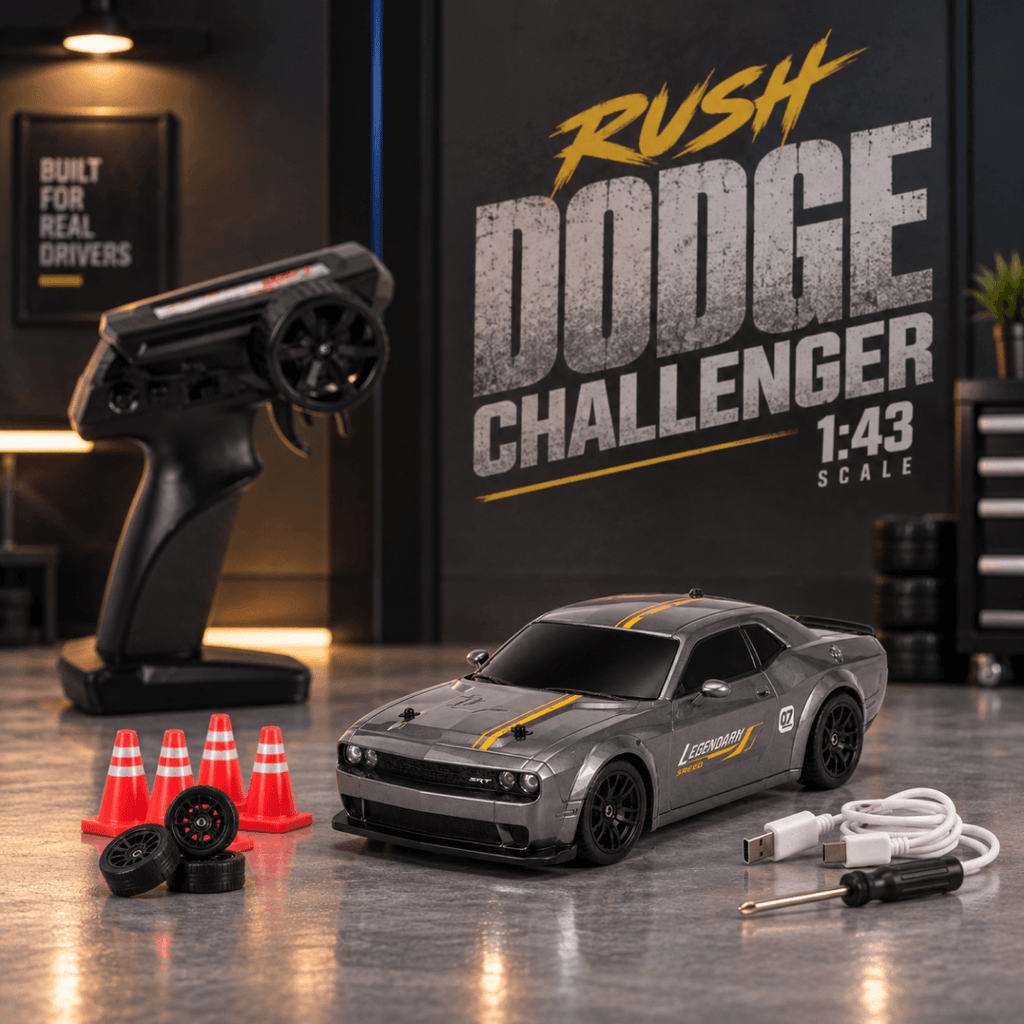 A 1:43 scale remote control model car in the style of a gray Dodge Challenger with yellow racing stripes, displayed alongside its black handheld transmitter, orange traffic cones, spare wheels, a USB charging cable, and a screwdriver on a polished gray tabletop. A large 'RUSH DODGE CHALLENGER 1:43 SCALE' sign is visible in the background.