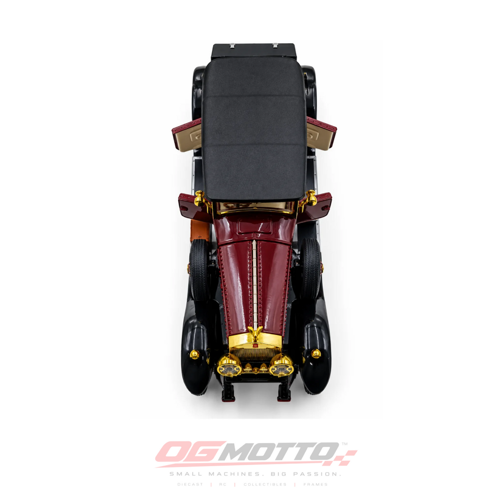 A vintage-style model car photographed from directly above on a white background, with a red body, black body panels and roof, and gold trim details. An OG MOTTO logo appears at the bottom of the image.